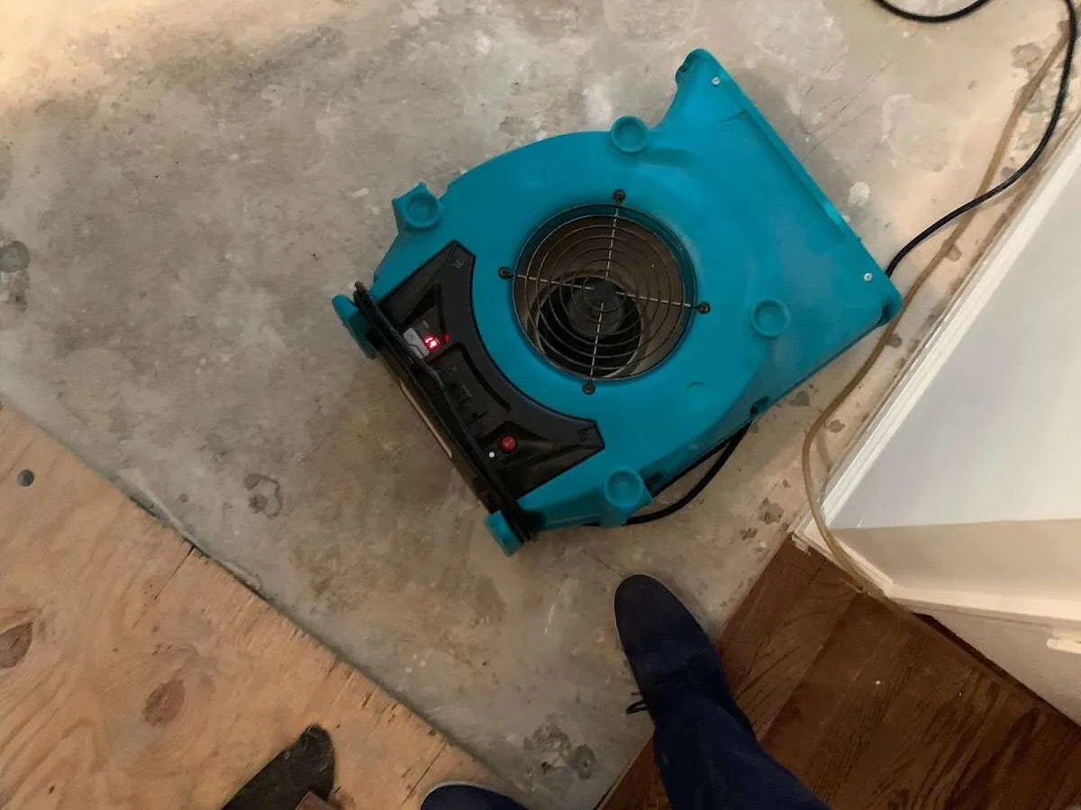 Air mover drying subfloor during Commercial Water Damage Restoration in Scituate